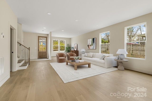 living room with light hardwood / wood-style flooring and plenty of natural light