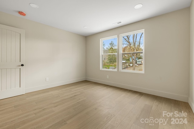 spare room featuring light hardwood / wood-style flooring