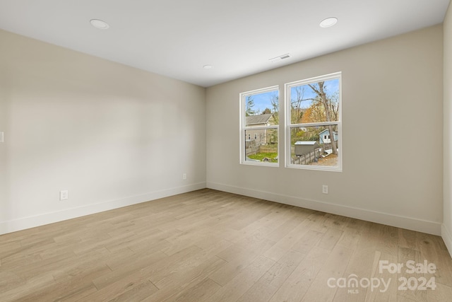 spare room featuring light wood-type flooring