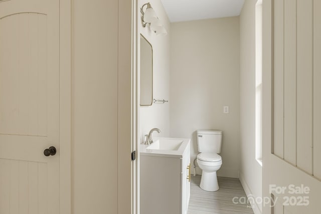 65 Bellevue Rd Unit 3, Asheville, NC 28803 - half bath featuring toilet, baseboards, vanity, and wood finished floors