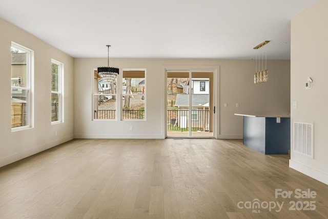 65 Bellevue Rd Unit 3, Asheville, NC 28803 - unfurnished dining area featuring a chandelier, light wood finished floors, and baseboards