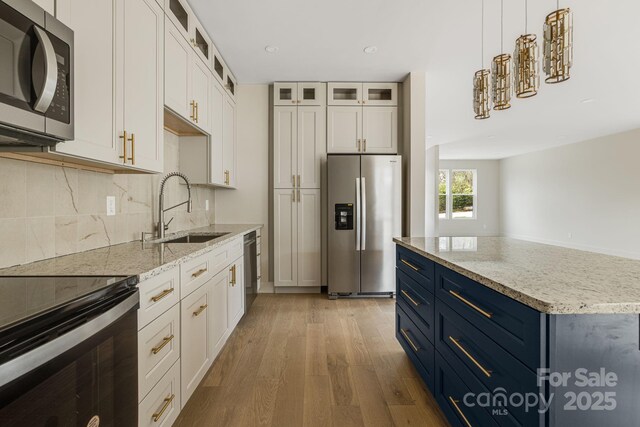 65 Bellevue Rd Unit 3, Asheville, NC 28803 - kitchen with stainless steel appliances, a sink, blue cabinets, wood finished floors, and recessed lighting