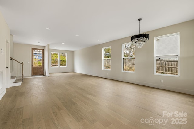 65 Bellevue Rd Unit 3, Asheville, NC 28803 - unfurnished living room with stairs, light wood finished floors, a chandelier, baseboards, and recessed lighting