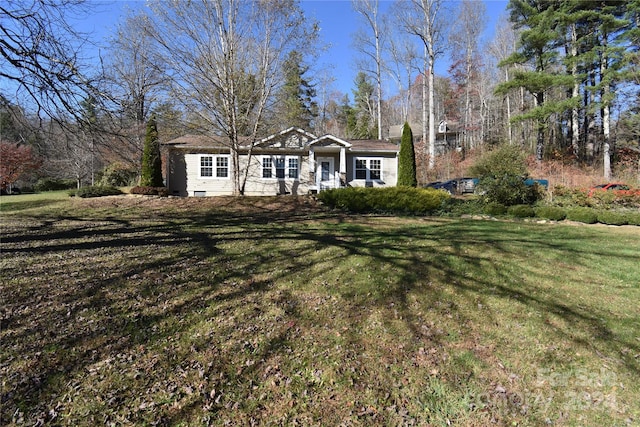 ranch-style home featuring a front yard