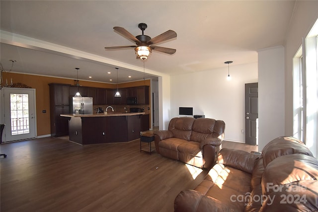 living room with dark hardwood / wood-style floors, ceiling fan, ornamental molding, and sink