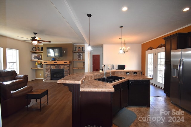 kitchen featuring an island with sink, a healthy amount of sunlight, and stainless steel refrigerator with ice dispenser