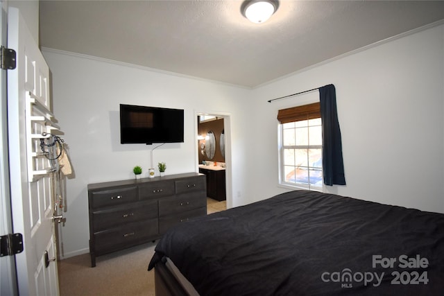 bedroom featuring light colored carpet, ensuite bath, and ornamental molding