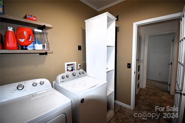 laundry area with ornamental molding and washing machine and clothes dryer