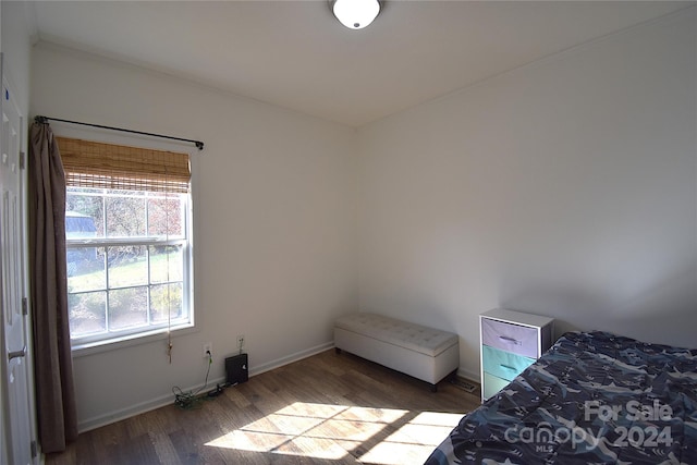 bedroom with dark wood-type flooring