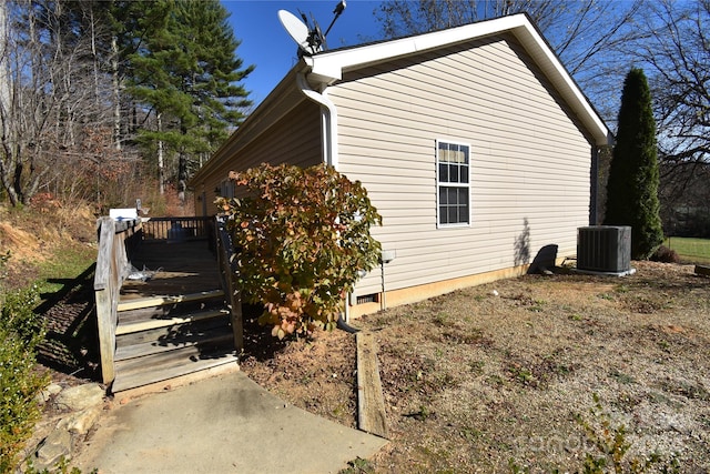 view of property exterior featuring central AC and a deck