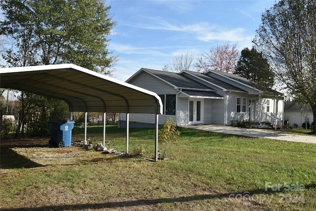 view of car parking featuring a carport and a lawn