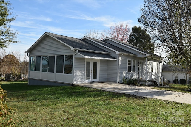 view of front facade with french doors and a front yard