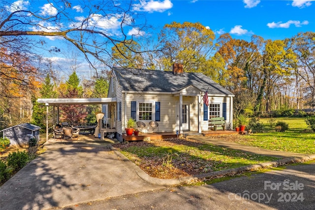 bungalow-style house with a carport and a front yard