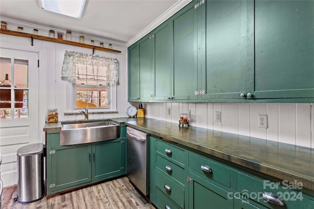 kitchen with stainless steel dishwasher, crown molding, sink, light hardwood / wood-style flooring, and green cabinetry