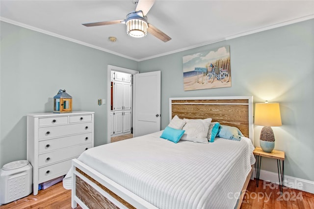 bedroom with light hardwood / wood-style flooring, ceiling fan, and crown molding