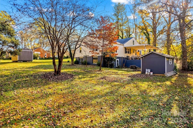 view of yard featuring a porch and a storage shed