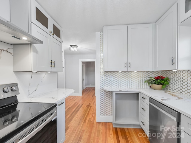 kitchen featuring dishwasher, white cabinets, range with electric cooktop, tasteful backsplash, and light hardwood / wood-style floors