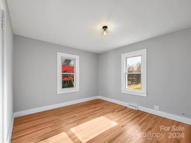 spare room with light hardwood / wood-style flooring