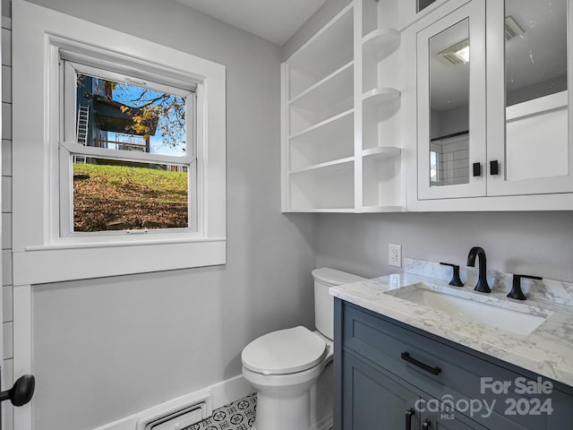 bathroom featuring tile patterned floors, vanity, and toilet