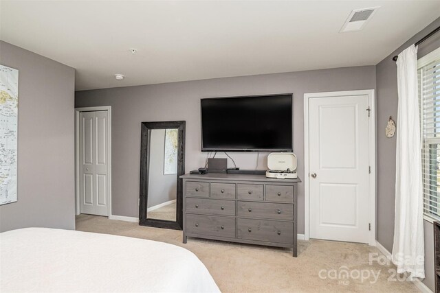 bedroom featuring light colored carpet