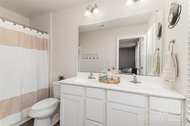 bathroom with vanity, toilet, and a shower with shower curtain