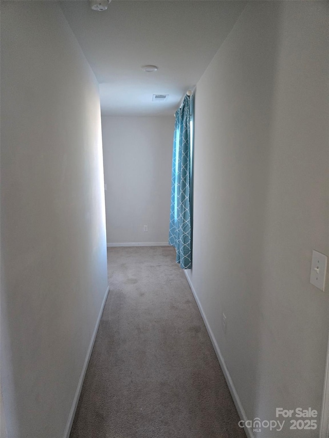 hallway featuring light carpet