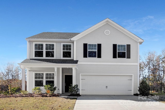 front of property featuring a garage and a front lawn