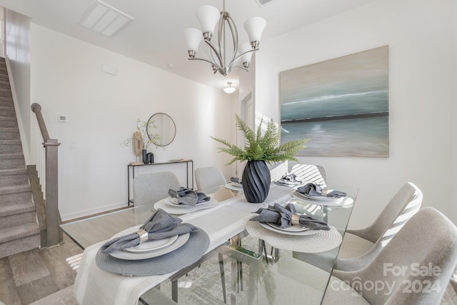 dining room featuring a chandelier and light wood-type flooring