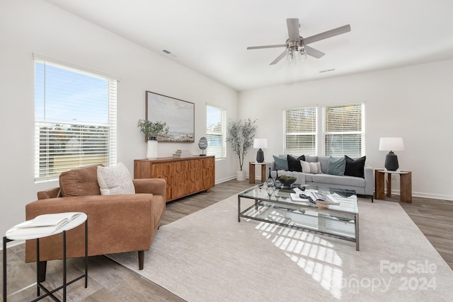 living room with hardwood / wood-style flooring, ceiling fan, and a healthy amount of sunlight