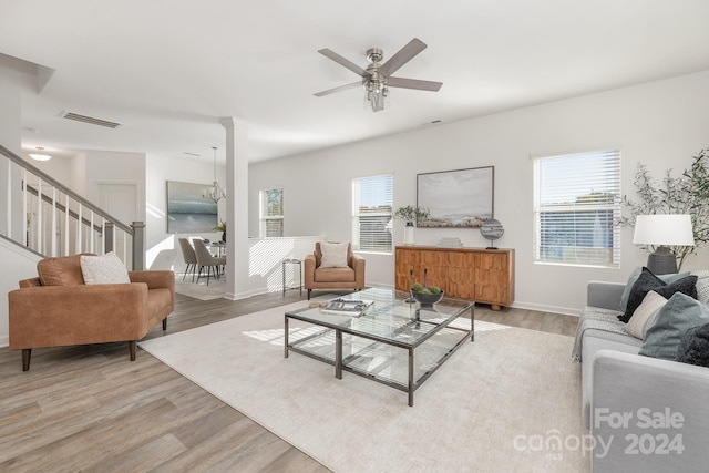 living room featuring light wood-type flooring and ceiling fan