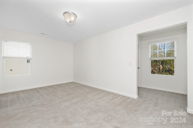 unfurnished room with light colored carpet