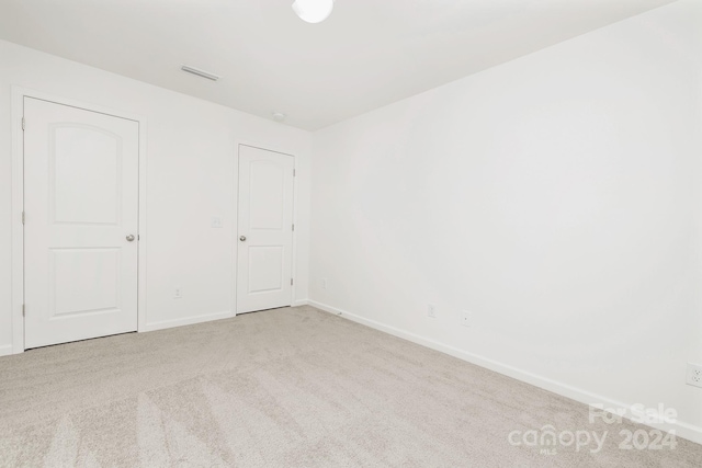 unfurnished bedroom with light carpet