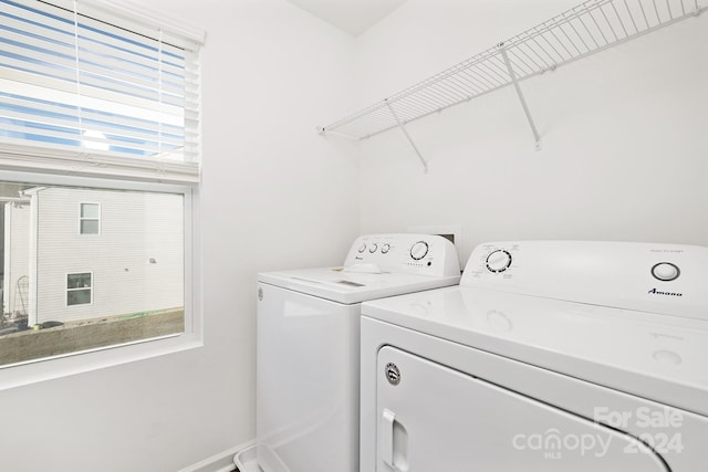 laundry area featuring washer and clothes dryer and a wealth of natural light