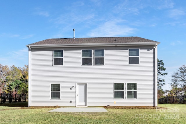 back of property featuring a yard and a patio