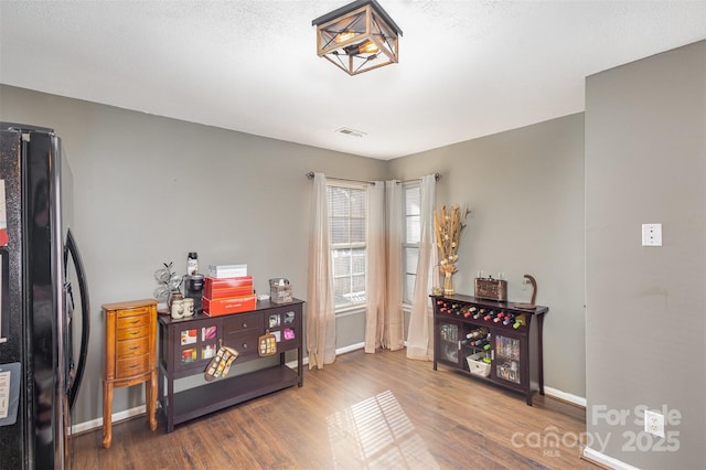 miscellaneous room featuring a textured ceiling and hardwood / wood-style flooring