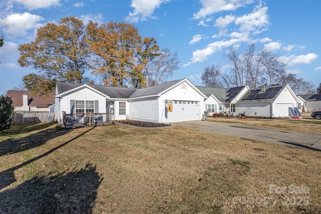 ranch-style home with solar panels, a garage, and a front lawn