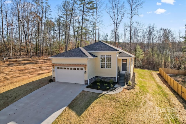 view of front of home with a garage and a front lawn