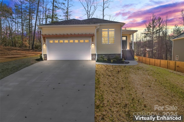 view of front of house featuring a yard and a garage