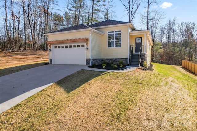 view of front of house featuring a garage and a front lawn