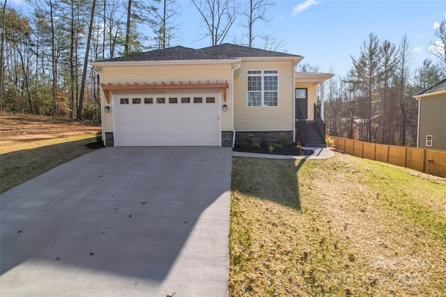 view of front of home featuring a front yard and a garage