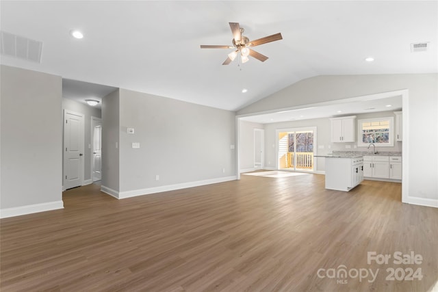 unfurnished living room with ceiling fan, light hardwood / wood-style flooring, lofted ceiling, and sink