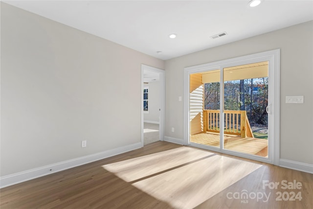 unfurnished room featuring hardwood / wood-style flooring