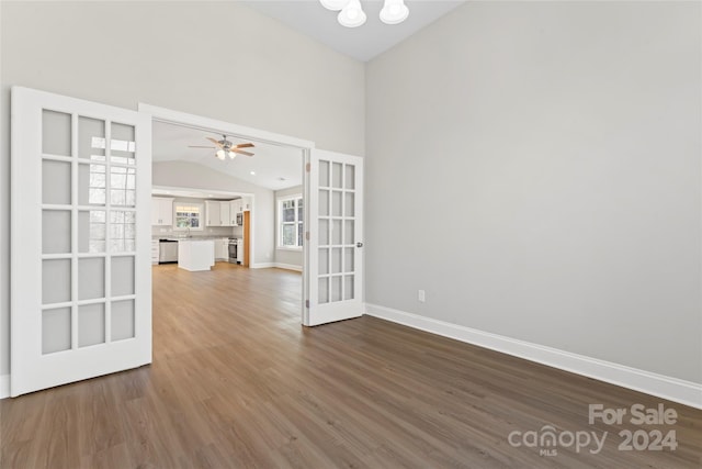 unfurnished room with french doors, hardwood / wood-style flooring, ceiling fan, and lofted ceiling