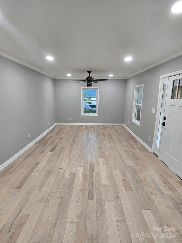 interior space with light hardwood / wood-style floors and crown molding