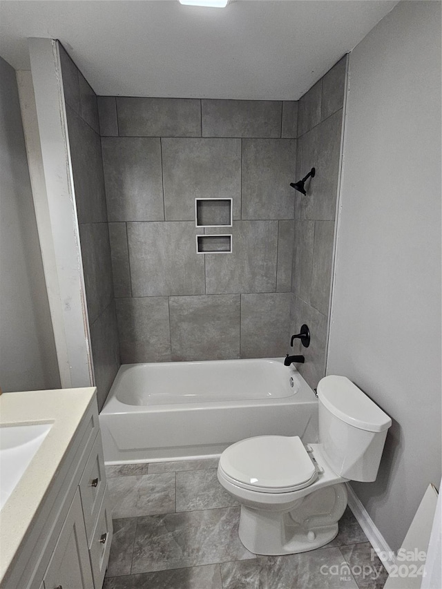 full bathroom with vanity, tiled shower / bath combo, and toilet