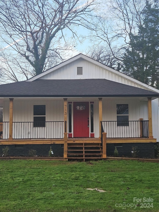 view of front of property with covered porch and a front yard