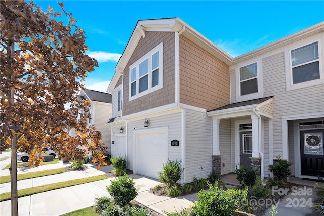 townhome / multi-family property featuring a garage