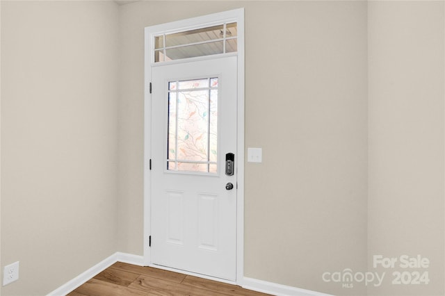 doorway with hardwood / wood-style flooring