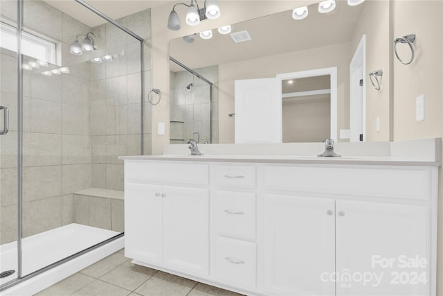 bathroom with tile patterned flooring, vanity, and an enclosed shower