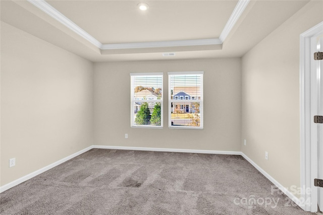 unfurnished room with carpet flooring, a raised ceiling, and ornamental molding